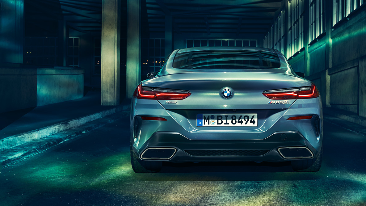 BMW 8 Coupé, hátulnézet. A BMW 8 Coupé hátulnézetből, éjszaka, városi környezetben.