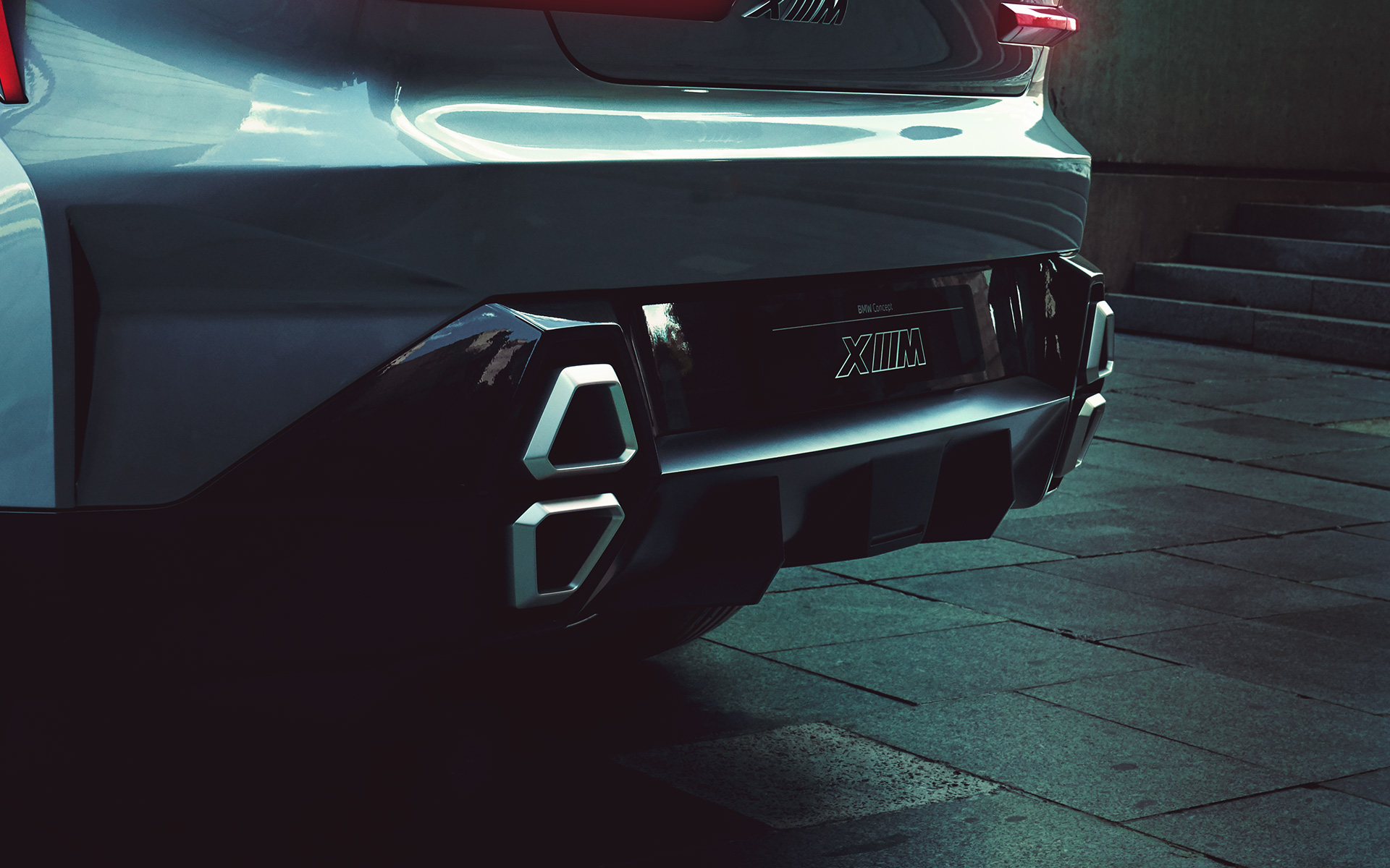 BMW Concept XM (G09), egy álló, rézsútos hátulnézetből látható autó kipufogói közelről BMW Concept XM (G09), egy álló, rézsútos hátulnézetből látható autó kipufogói közelről